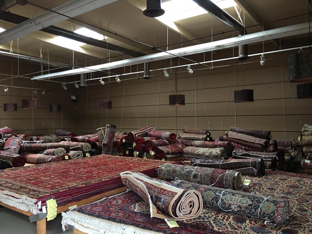 Rugs being moved into a new warehouse