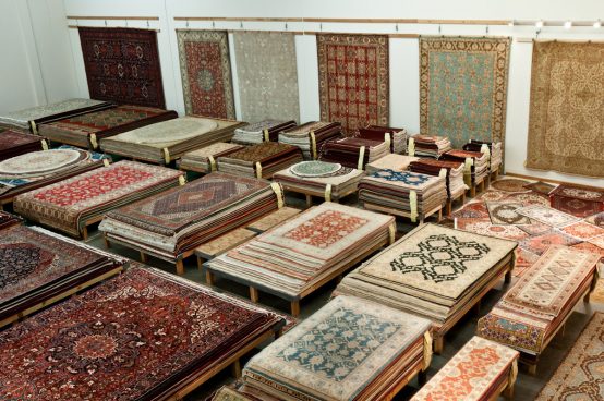 Piles of Persian Rugs and Oriental Rugs in Catalina Rug's Warehouse